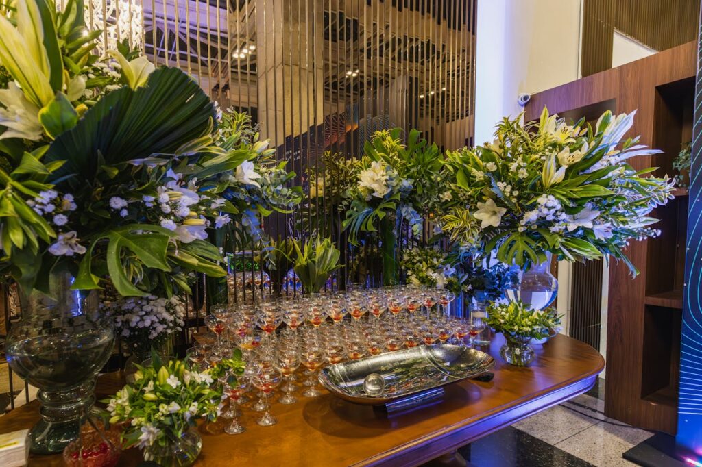 Luxurious floral arrangement with wine glasses set on a table, perfect for events.