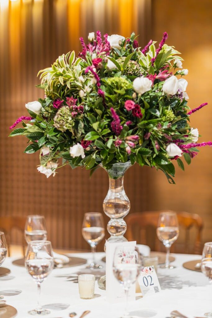 Sophisticated table setting with a stunning floral centerpiece at a wedding reception.