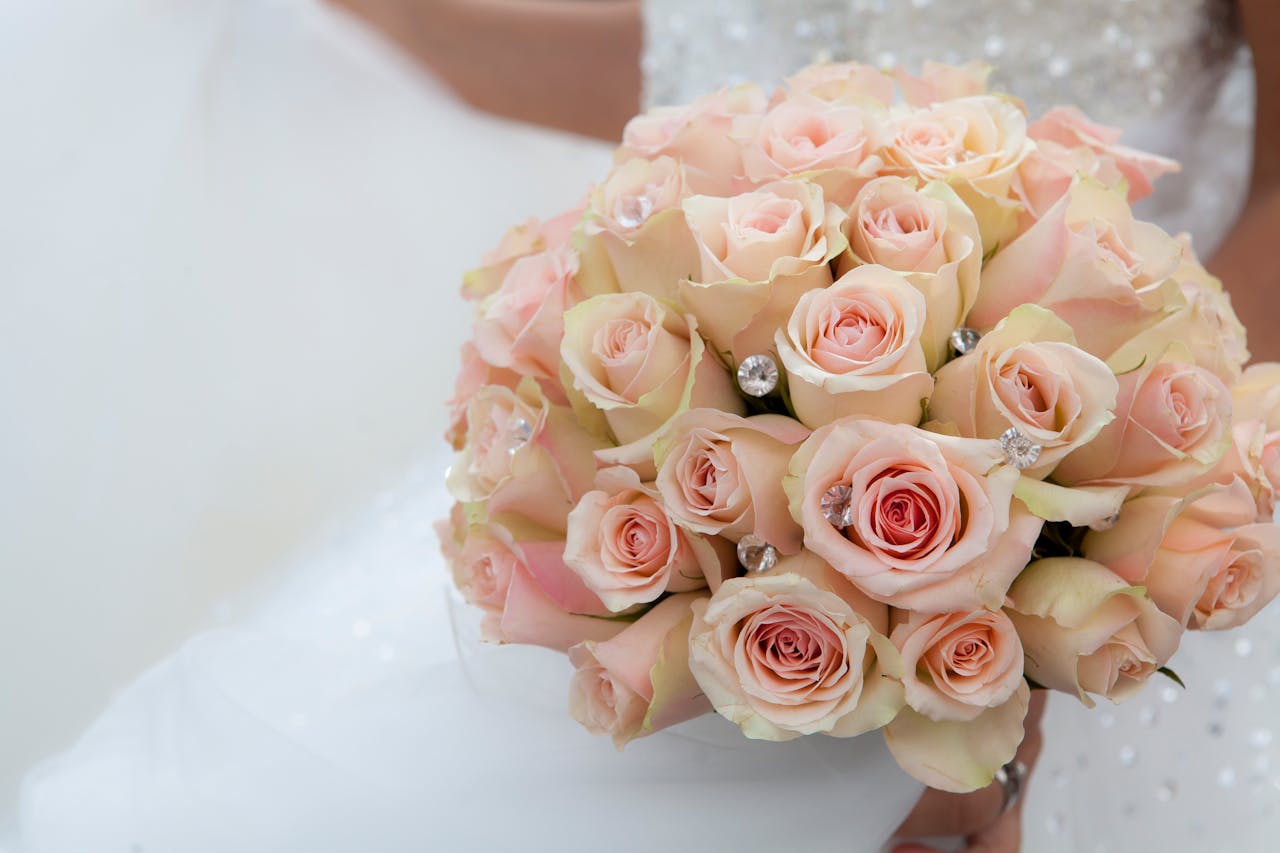 Close-up of a bridal bouquet with pale pink roses, perfect for weddings.