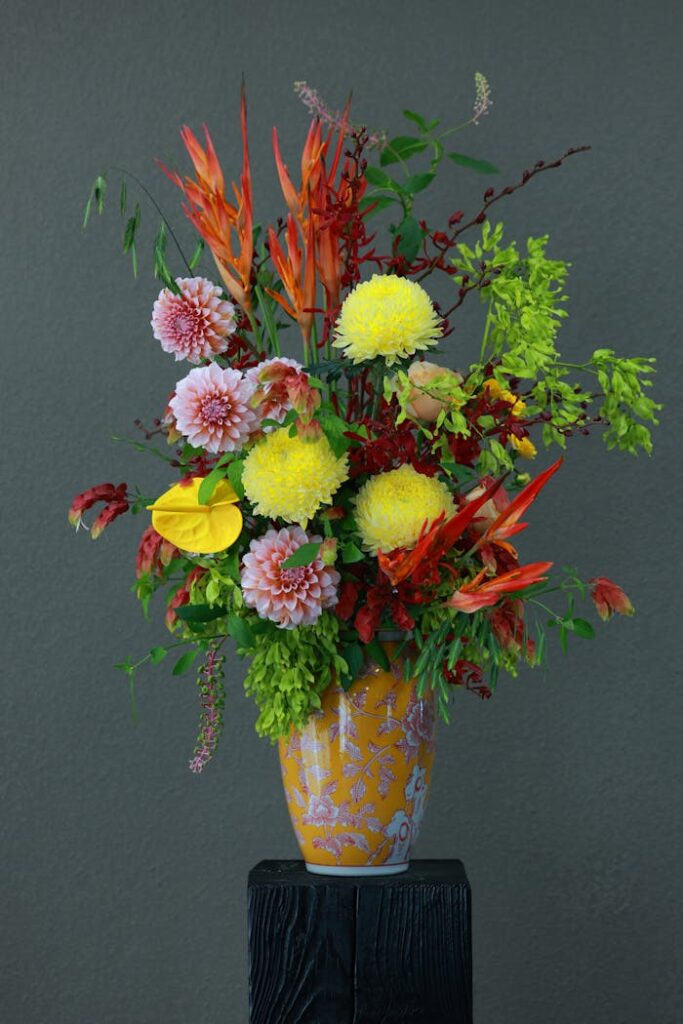 A colorful floral arrangement showcasing various flowers in an ornate vase.