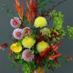 Colorful floral arrangement featuring a variety of exotic blooms in a decorative vase.