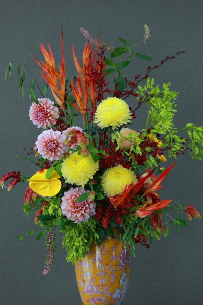 Colorful floral arrangement featuring a variety of exotic blooms in a decorative vase.